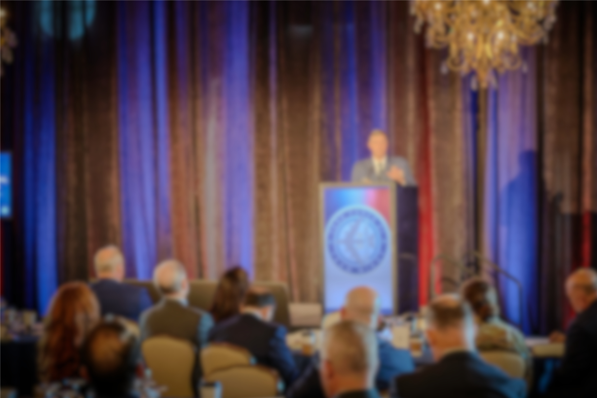 A room of guests listen to a keynote speaker at the symposium in Washington, D.C.