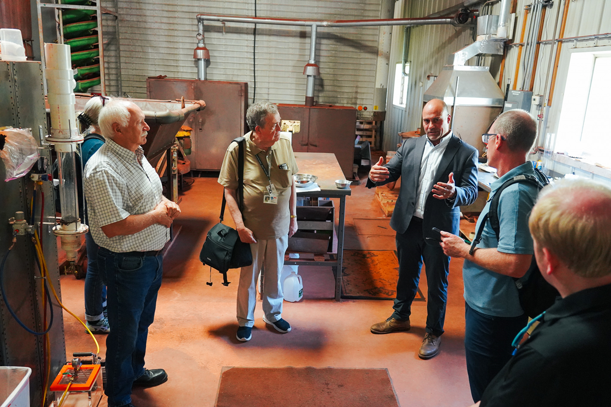 Jim Bougalis discusses the process of converting iron ore into pig iron with gathered media members.